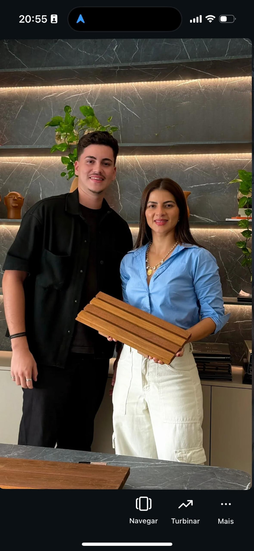Fundadores da Traço Prime apresentando amostra de painel ripado em madeira